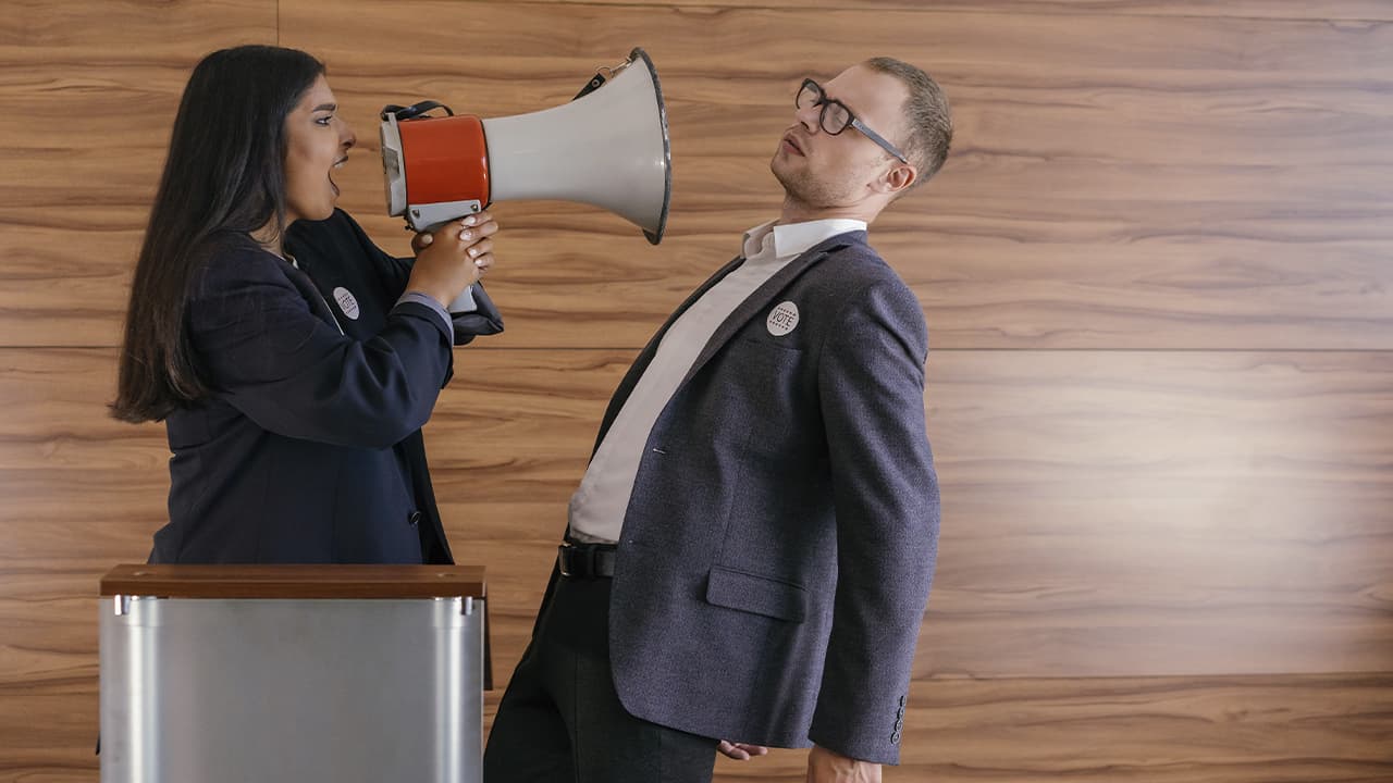 A woman with a loudspeaker and a man